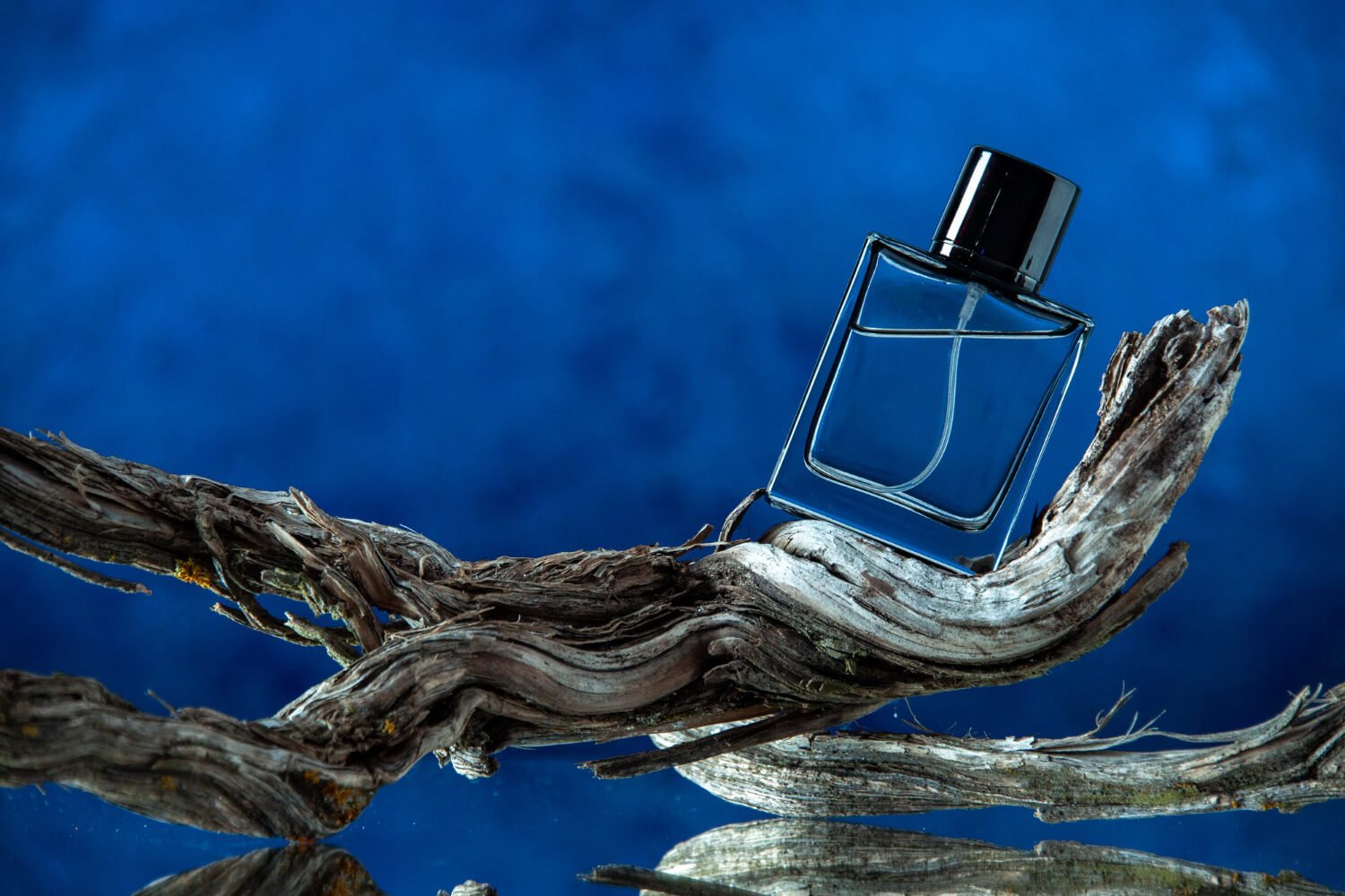 woody perfume displayed on a wood