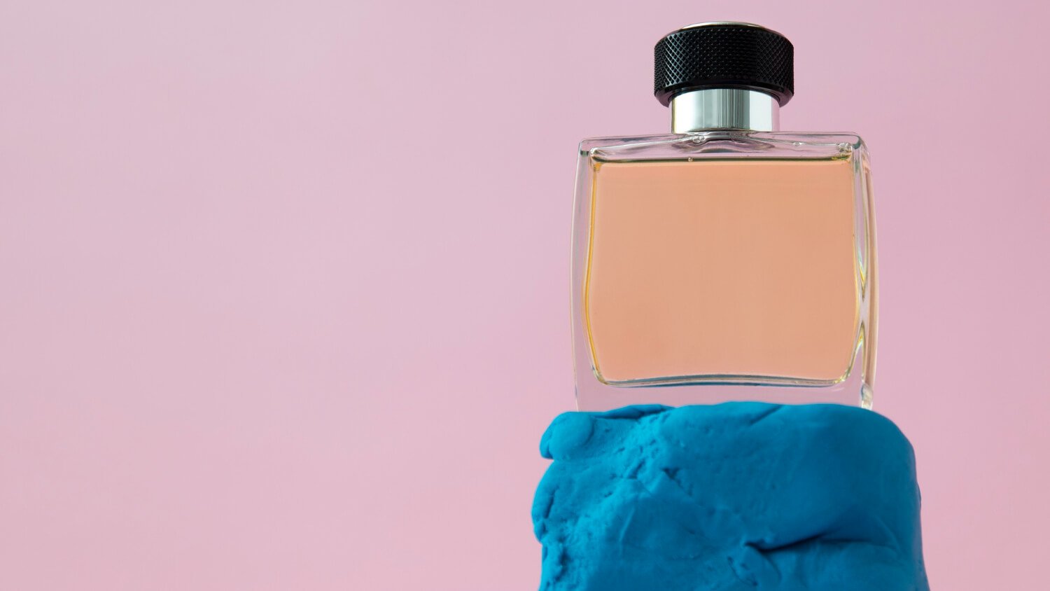 an affordable perfume standing on a colored stone