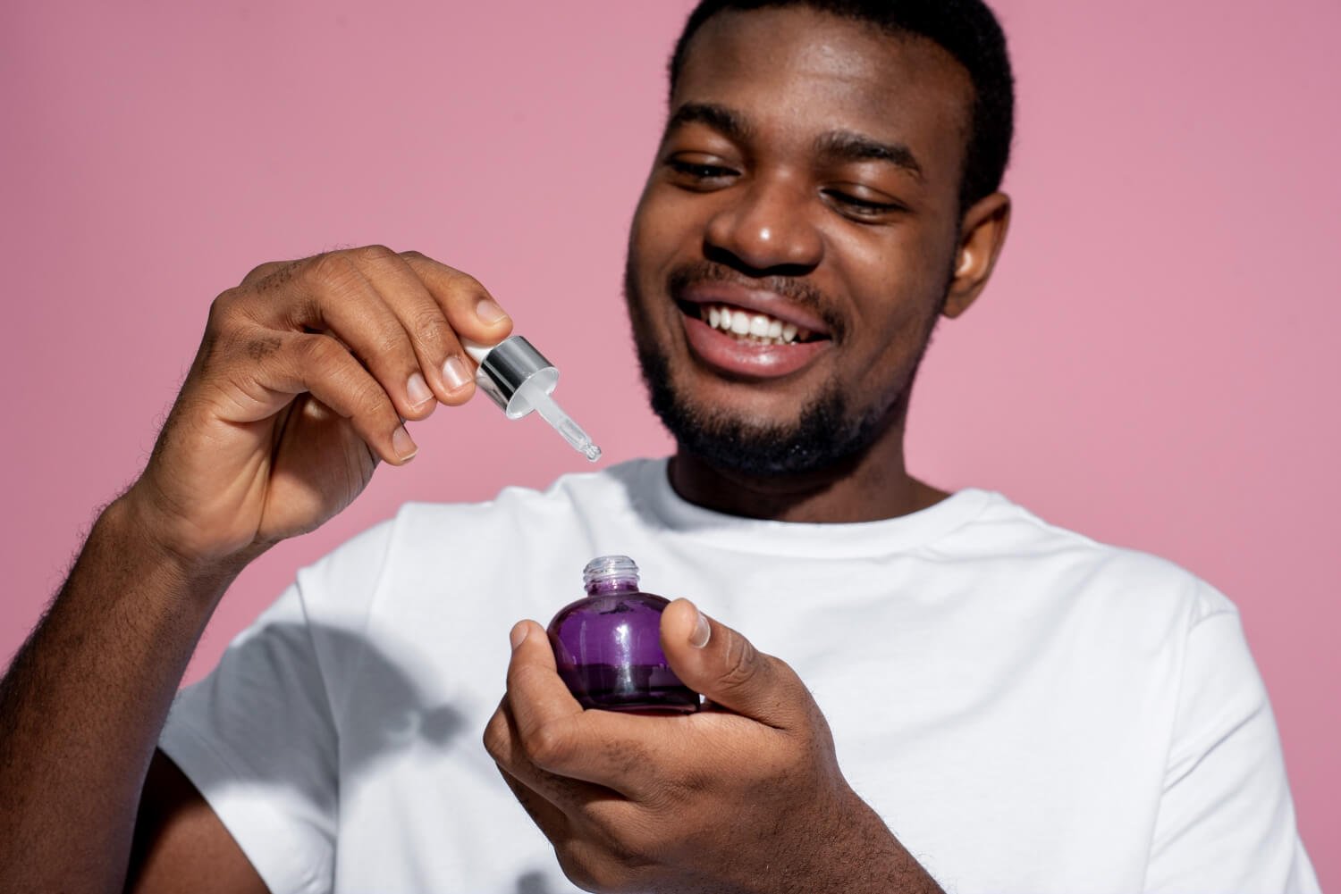 a man holding a perfume bottle